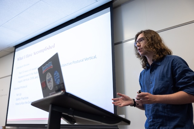 A male student presenting research